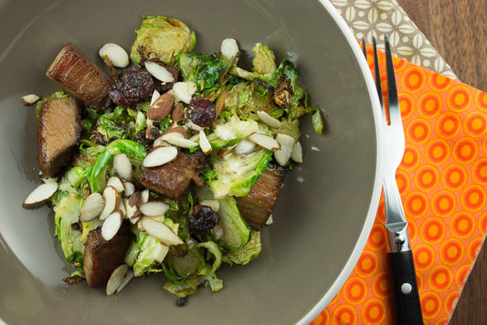 steak and brussels sprout skillet in a bowl with knife in the background 