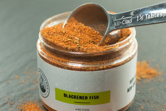 spice blends in a bottle with a spoon