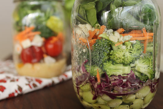 two salad jar of different veggies 