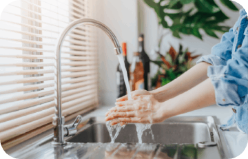 woman washing hands on sink 