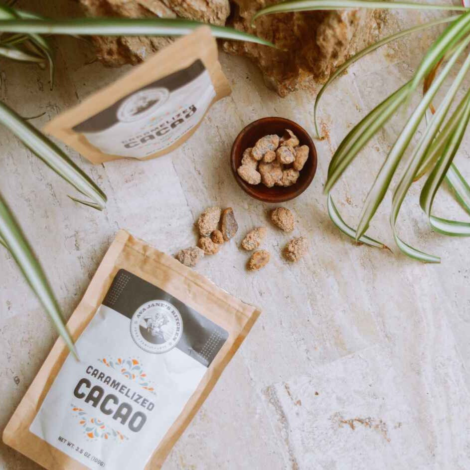 Caramelized Cacao nibs on a table next to a plant from Ava Jane Kitchen.