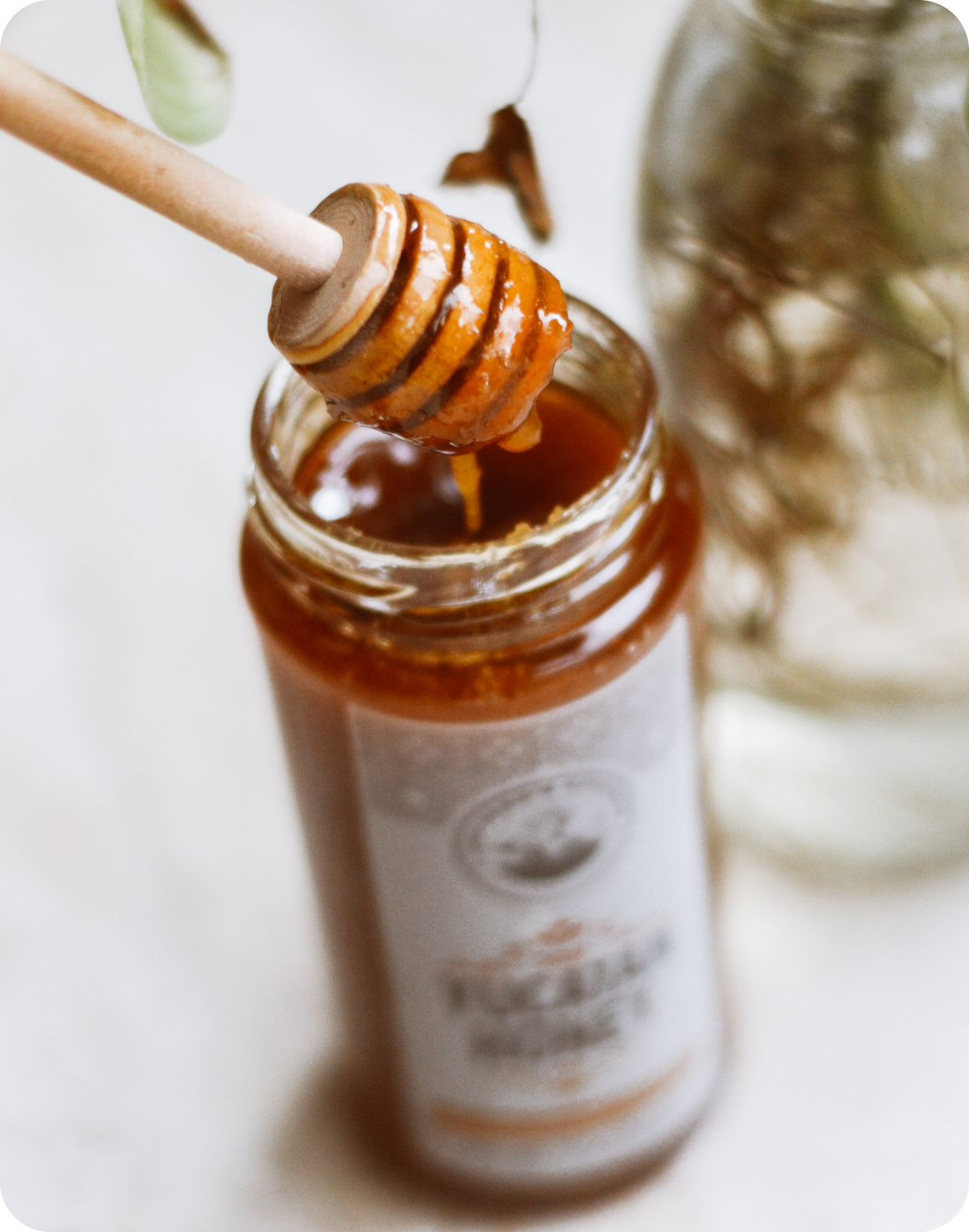 honey dipper coming out of a honey bottle