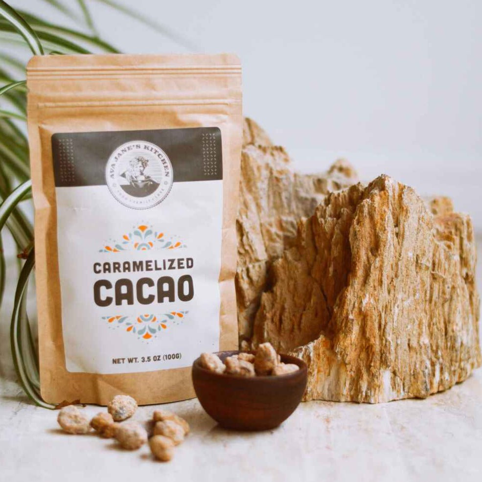 A bag of Ava Jane Kitchen's caramelized cacao sitting next to a plant.